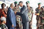 Ugandan president Yoweri Museveni being decorated  by his counterpart Paul Kagame on liberation day.
