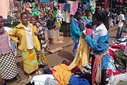 A business woman at Nyabugogo market convinces a customer to buy her clothes (File photo)