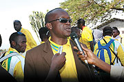 Joseph Habineza talking to the press at Kigali International airport on Tuesday as he and thousands of other Rwandans were welcoming the 2009 Kagame Cup winners Atraco. 
