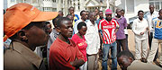 The Construction workers stand in front of the building yesterday. (Photo J. Mbanda)
