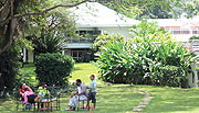 A family enjoys the cool breeze in the tree shade at the hotel. (Photo / S. Ntayombya)
