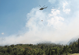 A Rwanda Air Force chopper putting  out the fires in the virungas (Photo by B. Mukombozi).
