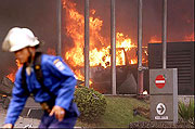 Fire personel attempting to put of the fires caused by the suicide bomb attack on JW Marriott and Ritz-Carlton hotel, Jakarta, Indonesia