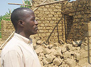 Niyitegeka looks at his demolished house (Photo: G. Gasarasi)