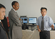 President Kagame listens to a Star Media Africa official during the launch of the 3rd payTV in Kigali