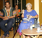 Ambassador Cynthia Shepard (right) shows her book u201cAll things Being Equalu201d to Amin Gafaranga, the founder of Shokola during the launch of the African Literature Library. (Photo, by H. Goodman)