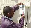 An electrician fixing a pre-paid meterbox.