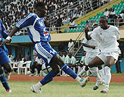 APRu2019s Mbuyu Twite fights for the ball with a Maranatha player. APR were yesterday knocked out of the MTN Peace Cup. (File photo)