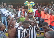 CHAMPIONS: APR captain Mbuyu Twite lifts the league trophy after yesterdayu2019s 2-0 win over Mukura at Huye stadium. (Photo/ P. Ntambara)