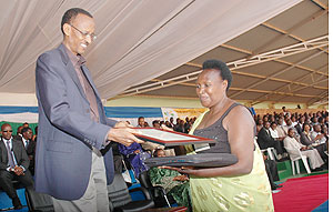 President Paul Kagame awards Epiphanie Mukashyaka as one of the best Tax payers during the Tax payers' day celebrations in Gicumbi Yesterday. (Photo J Mbanda)