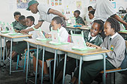 Children of Green hills Academy admire something on a computer. Pupils in villages should be exposed to computers too(File photo).