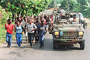 Interahamwe militia training beside the french patrol car(File photo).