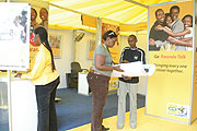 MTN Rwanda employees at an MTN stand during a recent exposation (File Photo)