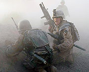 A U.S. Marine and an Afghan soldier react after an IED explosion while under enemy fire in Mian Poshteh, Afghanistan, on July 17, 2009
