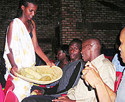 Sharing the harvest_ Show goers served Maize during the celebration of Umuganura by the NUR traditional ballet group. (Photo by, P. Ntambara)