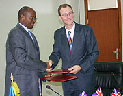 Minister of Finance James Musoni (L) and Martin Leach, the head of DFID Rwanda after the signing. (Photo; F. GOODMAN)
