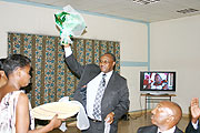 Iu2019M OFF; Former Minister of Local Government Protais Musoni after receiving a gift from the ministry staff during his farewell (Photo; F. Goodman)