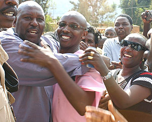 Frank Kalisa being congratulated by friends and relatives outside court yesterday after his release. (Photo by F. Goodman)