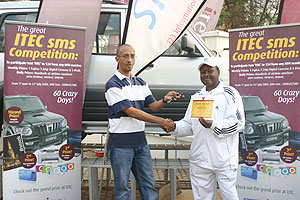 Marc Deleu(L) congraturating Jean-Damascene Mushana ,in the background is the Scorpio he won. ( Photo/ F. Goodman)