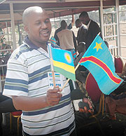 A Congolese journalist admires flags of Rwanda and DRCongo, a sign of the Umoja wetu spirit.