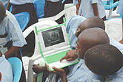 Primary School boys try to surf the Internet with one of the Laptops given to them. (File Photo)