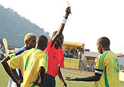 Referee Issa Kagabo brandishing a booking to Ismail Nshutinamagara during last yearu2019s Amahoro Cup semifinal between Atraco and Rayon Sport.
