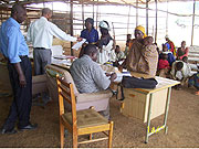 UNHCR and Ministry of Local government officials registering returnees at Gicumbi transit camp on Thursday (photo/A Gahene)