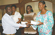 Kigali City Vice Mayor Jeanne du2019Arc Gakuba handing over  books to teachers in Kigali City to mark the launch of the campaign. (Photo/ F. Goodman)