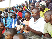 Members of velo-motorbike association screen the bank booklets for balances. 