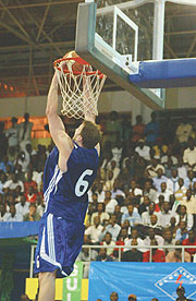 TOP REBOUNDER: Rwandau2019s Robert Thompson takes a dunk during the Zone 5 Championship in staged in Kigali eraly this year. Thompson won the Best Rebounder award at the Fiba Afrobasket Championships in Libya.