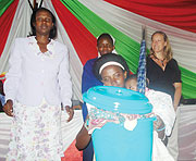 A beneficiary walks away with her reward at the intrahealth ceremony. (Photo/ D.Sabiiti)