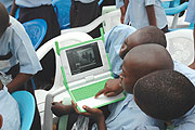 Kagugu Primary School boys try to take photographs with one of the Lap tops given to them. It might take longer for others to receive such laptops