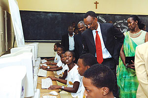 President Paul Kagame inspects Groupe Scolaire Notre Dame de Karubanda students as they work in the computer lab. On his left is First Lady Jeannette Kagame who was honoured by the school for her role in promoting the girl childu2019s education.(Photo/U.V)