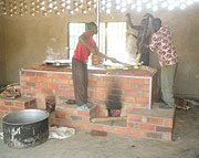 Cooks at Mayange Primary school use the stove for the first time. (Photo Irene V. Nambi).