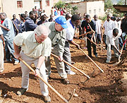 US Senators Johnny Isakson and Bob Corker participate in a road widening project for Umuganda. This kind of community participation is commendable.