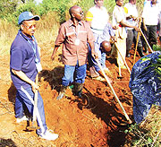 WFP country representative (with a hat) paticipates in the umuganda. 
