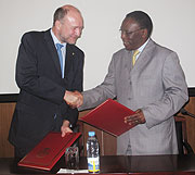  Eugu00e8ne Munyakayanza and Niels Breyer shaking hands after signing a cooperation agreement at the end of the meeting yesterday (Courtesy Photo).