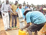 WATER IS LIFE:  Gasagara residents fetch water at the water projectu2019s launch, on Saturday.
