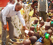 Dr Theogene Rutagwenda serves children milk at the cow giving ceremony