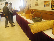 Chinese Diplomat shows a local journalist some of the Bamboo artcraft pieces to be exhibited. (Photo E Mutara)