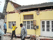 Residents gathered to closely look at the house whose roof curved in. (Photo: B. Mukombozi)