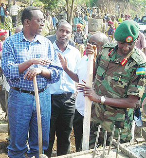 Prime Minister Bernard Makuza and other officials participate in the construction of five classrooms in Kimonyi, Musanze district. (Photo B Mukombozi)