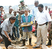 Jeanne du2019Arc Gakuba  laying a foundation stone for the construction of 9-YBE blocks in Nyarugenge district flanked  by Origene Rutayisire, Nyarugenge Mayor. ( Photo: F. Goodman)