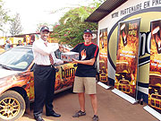 Olivier Costa receives a cartoon of Burn energy drink from Bralirwau2019s marketing manager Freddy Nyangezi. 