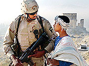 A US soldier chatting with an Afghan youth in Kandahar Province, Southern Afghanistan.