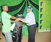 Fraterne Rubangura receives a golf bag from KCB Rwandau2019s Managing Director