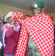 A Masai elder dresses the Rwanda Defence Forces Chief of Defence Staff Gen James Kabarebe with a Masai shuka yesterday in Monduli. (Photo/ G. Muramira)