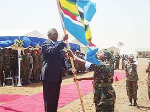 The Minister of Defence, Gen Marcel Gatsinzi, receiving the East African flag yesterday at Monduli, Tanzania (Photo/ G. Muramira)