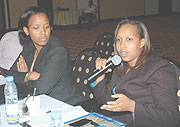 Sayinzoga Kampeta, the Director of Macroeconomic Policy Unit at the Ministry if Finance speaks as Clare Akamanzi look on. (Photo J. Mbanda)