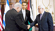U.S. President Barack Obama looks on as Israeli Prime Minister Benjamin Netanyahu  and Palestinian President Mahmoud Abbas shake hands before a trilateral meeting at the Waldorf-Astoria in New York.